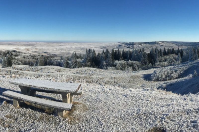 frost-covered picnic table against a winter valley